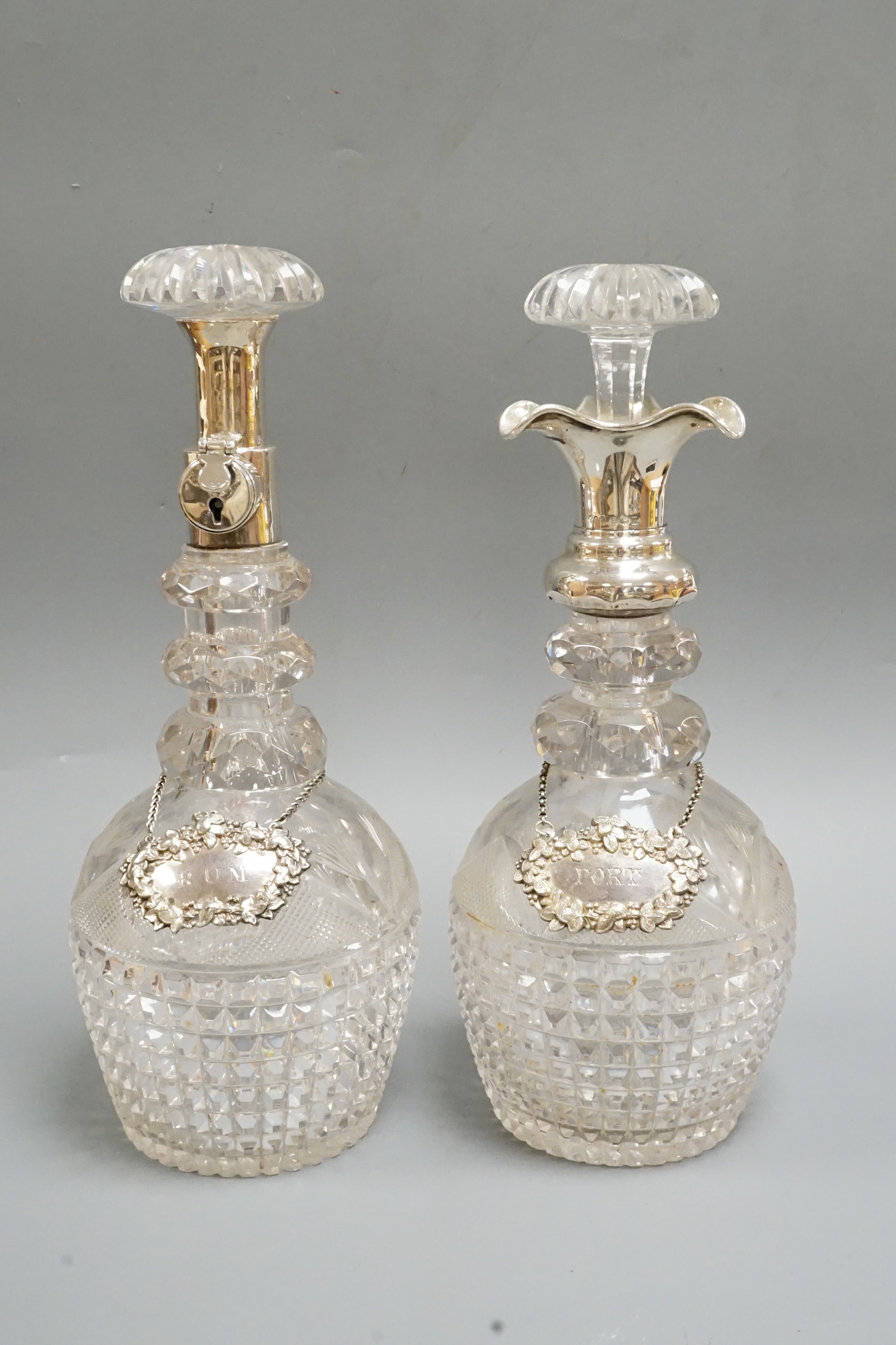 A near pair of George V silver mounted cut glass decanters and stoppers, by Hukin & Heath, Birmingham, 1922, approx. 30.7cm.